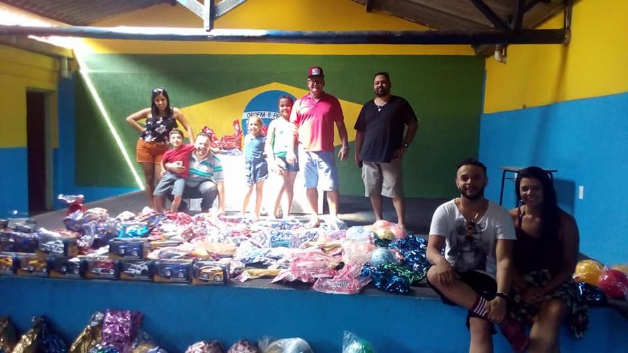 Salão da associação reformado, com mural da bandeira e a comunidade reunida